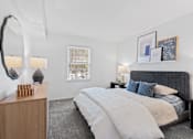 Thumbnail 10 of 25 - a bedroom with a bed and a mirror at Courthouse Square Apartments, Towson, MD, 21286