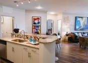 Thumbnail 1 of 30 - Kitchen with island looking into living room at Sycamore at Tyvola, North Carolina, 28217