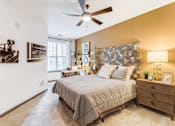 Thumbnail 5 of 18 - a bedroom with a bed and a ceiling fan at Dartmoor Place at Oxford Square Apartments, Hanover