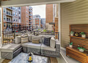 Thumbnail 9 of 18 - patio with a couch and a table at Dartmoor Place at Oxford Square Apartments, Maryland, 21076