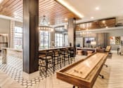 Thumbnail 15 of 18 - Community room with shuffleboard table  at Dartmoor Place at Oxford Square Apartments, Maryland
