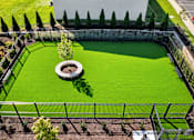 Thumbnail 20 of 25 - an aerial view of a dog park with green grass and a fountain at Courthouse Square Apartments, Towson, 21286