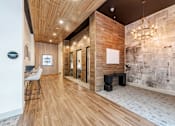 Thumbnail 22 of 26 - A hallway with a wooden floor and a stone wall at The Edison Lofts Apartments, Raleigh, NC