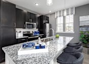 Thumbnail 4 of 25 - Kitchen with granite countertop at Elevate at Brighton Park, South Carolina, 29486