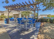 Thumbnail 26 of 41 - a patio with a pergola and tables and chairs at Fortress Grove, Tennessee