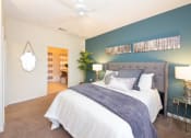 Thumbnail 20 of 41 - a bedroom with a large bed and a blue accent wall at Fortress Grove, Murfreesboro