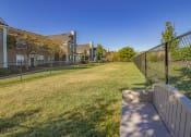 Thumbnail 39 of 41 - Pet run with green grass, a fence and bench  at Fortress Grove, Murfreesboro, Tennessee