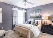 Thumbnail 14 of 41 - a bedroom with gray walls and a ceiling fan at Fortress Grove, Murfreesboro