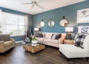 Thumbnail 17 of 41 - a living room with blue walls and a ceiling fan at Fortress Grove, Murfreesboro, Tennessee