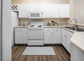 Thumbnail 2 of 22 - A kitchen with white cabinets at Henley Tampa Palms Apartments, Tampa, Florida