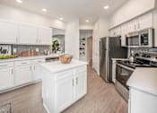 Thumbnail 6 of 22 - a large kitchen with white cabinets and stainless steel appliances at Henley Tampa Palms Apartments, Tampa, FL, 33647