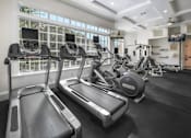 Thumbnail 15 of 22 - the gym is equipped with treadmills and other exercise equipment at Henley Tampa Palms Apartments, Tampa