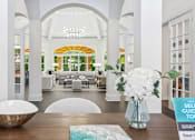 Thumbnail 19 of 22 - resident lounge with a table and a vase of flowers at Henley Tampa Palms Apartments, Tampa, FL