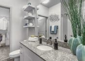 Thumbnail 12 of 30 - Bathroom with granite counters and large mirror at Sycamore at Tyvola, Charlotte, NC, 28217