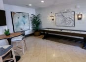 Thumbnail 41 of 54 - Resident lounge with shuffleboard  area at Two Addison Place Apartments , Pooler, 31322
