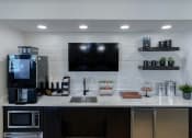 Thumbnail 37 of 54 - Coffee bar in the resident lounge  at Two Addison Place Apartments , Pooler, GA, 31322
