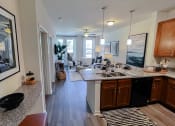Thumbnail 13 of 54 - Open living area kitchen looking into bedroom at Two Addison Place Apartments , Pooler, GA, 31322