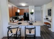 Thumbnail 9 of 54 - Kitchen with breakfast bar at Two Addison Place Apartments , Georgia, 31322