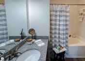 Thumbnail 12 of 54 - Vanity and tub/shower at Two Addison Place Apartments , Pooler, GA, 31322