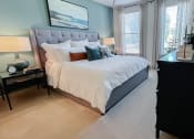 Thumbnail 15 of 54 - Model bedroom with large bed and lots of light  at Two Addison Place Apartments , Georgia
