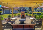 Thumbnail 27 of 54 - Outdoor fireplace lounge at Two Addison Place Apartments , Pooler, GA
