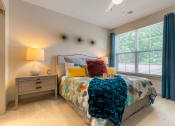 Thumbnail 4 of 21 - Bedroom with bed and nightstand at 1010 Dilworth Apartments, Charlotte, 28204