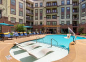Thumbnail 9 of 21 - Swimming pool with tanning ledge at 1010 Dilworth Apartments, Charlotte