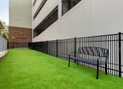 Thumbnail 11 of 21 - Dog park with bench and turf grass at 1010 Dilworth Apartments, Charlotte, 28204
