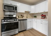Thumbnail 1 of 31 - a kitchen with white cabinets and stainless steel appliances at Padonia Village Apartments, Timonium MD