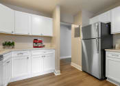 Thumbnail 7 of 31 - a kitchen with white cabinets and a stainless steel refrigerator at Padonia Village Apartments, Timonium MD