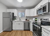 Thumbnail 1 of 41 - a kitchen with stainless steel appliances and white cabinets at Westwinds Apartments, Annapolis