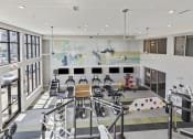 Thumbnail 18 of 38 - the lobby of a gym with chairs and a large wall of windows at Central Island Square, Daniel Island, South Carolina