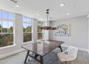 Thumbnail 29 of 38 - a dining room with a table and chairs and windows at Central Island Square, Daniel Island, 29492