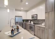 Thumbnail 14 of 26 - Kitchen with Island at Millworks Apartments, Atlanta