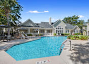 Thumbnail 22 of 33 - a swimming pool with a house in the background at Sweetgrass Landing, South Carolina, 29466