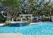 Thumbnail 23 of 33 - a large swimming pool with a jacuzzi and some trees at Sweetgrass Landing, Mount Pleasant