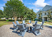 Thumbnail 27 of 33 - a patio with a fire pit and chairs in front of a house at Sweetgrass Landing, Mount Pleasant