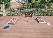 Thumbnail 5 of 20 - outdoor games on wooden deck at McDonogh Township Apartments, Owings Mills, MD