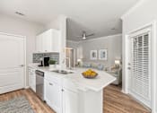Thumbnail 11 of 33 - A kitchen with white cabinets and a bowl of fruit on the counter at Sweetgrass Landing, Mount Pleasant, SC