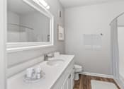 Thumbnail 20 of 33 - A white bathroom with a sink, mirror, toilet, and bathtub at Sweetgrass Landing, Mount Pleasant, South Carolina, 29466
