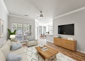 Thumbnail 13 of 33 - A living room with a white couch, a wooden coffee table, and a flat-screen TV mounted on the wall at Sweetgrass Landing, Mount Pleasant, South Carolina