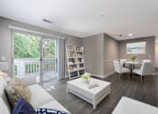 Thumbnail 7 of 20 - a living room and dining room with a sliding glass door at The Village Apartments, Raleigh, North Carolina