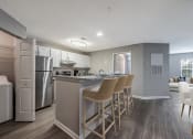 Thumbnail 1 of 20 - kitchen and bar with stools  at The Village Apartments, Raleigh, 27615