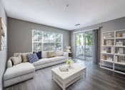 Thumbnail 2 of 20 - a living room with a white couch and a coffee table  at The Village Apartments, Raleigh, North Carolina