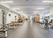 Thumbnail 12 of 16 - A spacious gym with a variety of equipment at The Linden Apartments, North Carolina 28036