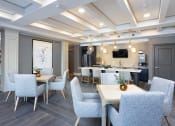 Thumbnail 30 of 33 - Community lounge with tables and chairs at St Mary's Square North Apartments, Raleigh, NC