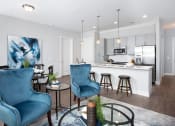 Thumbnail 1 of 33 - Living room and kitchen with island at St Mary's Square North Apartments, Raleigh, NC, 27605