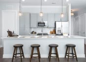 Thumbnail 6 of 33 - Kitchen island with bar stool seating  at St Mary's Square North Apartments, Raleigh, North Carolina