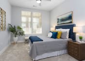 Thumbnail 16 of 33 - Primary bedroom with bed and side tables at St Mary's Square North Apartments, Raleigh, North Carolina