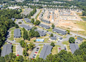 Thumbnail 23 of 46 - A bird's eye view of a residential area with houses and cars.